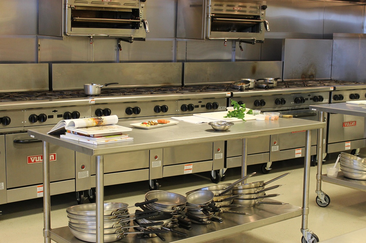 Food business staff completing digital food safety records in a kitchen